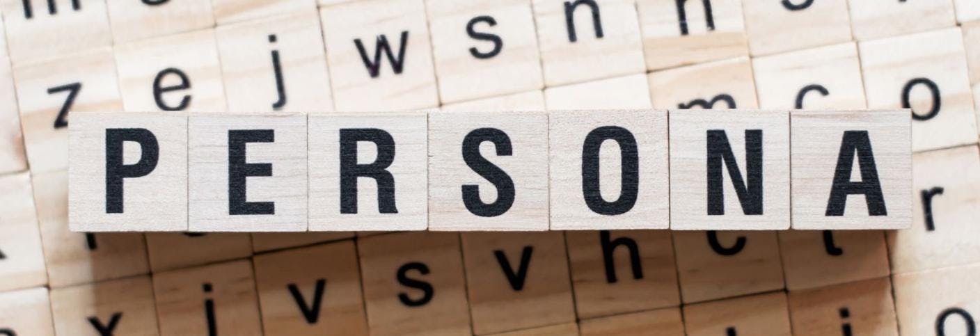 Wooden blocks with letters forming the word "persona". 
