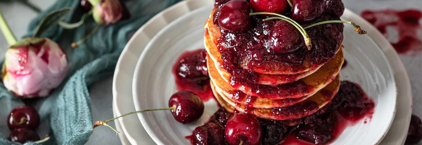 A stack of pancakes & jam.